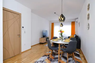 a dining room with a table and chairs at Sara Apartments in Visoko