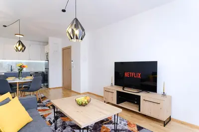a living room with a tv and a table at Sara Apartments in Visoko