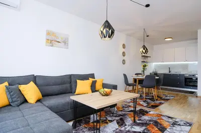 a living room with a couch and a table at Sara Apartments in Visoko