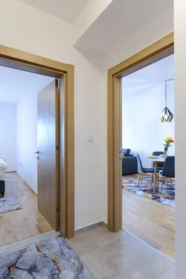 a living room with a door open to a dining room at Sara Apartments in Visoko