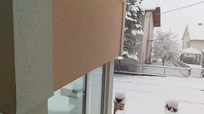 a window of a building with snow on the ground at Apartman Bor in Livno