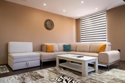 a living room with a couch and a table at Ema, Asja, Eda Apartments in Zenica
