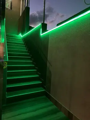 a staircase with green lights on the side of a building at Ema, Asja, Eda Apartments in Zenica