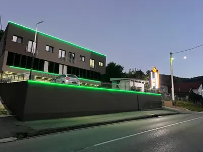 a building with green lights on the side of a street at Ema, Asja, Eda Apartments in Zenica