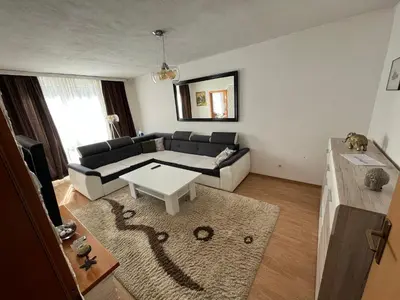 a living room with a couch and a table at Apartman Harmani in Bihać