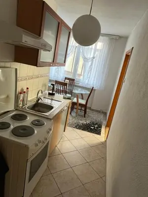 a kitchen with a sink and a stove top oven at Apartman Harmani in Bihać