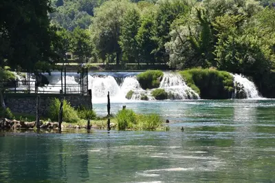 a river with a waterfall in the background at Unique Una in Ripač