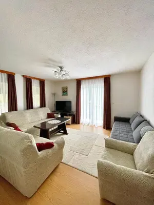 a living room with two couches and a table at Unique Una in Ripač