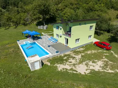 an aerial view of a house with a swimming pool at Greenoasis Bihac in Bihać