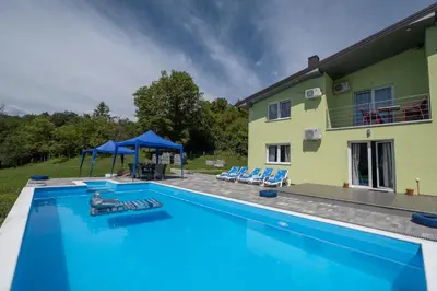 an image of a swimming pool in front of a house at Greenoasis Bihac in Bihać