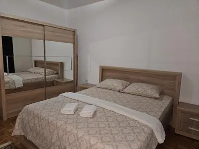 a bedroom with two beds and a large mirror at Meri in Jajce