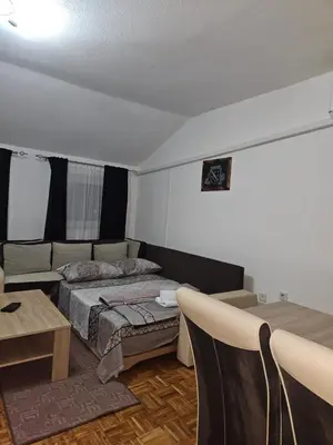 a bedroom with a bed and a couch and a table at Meri in Jajce