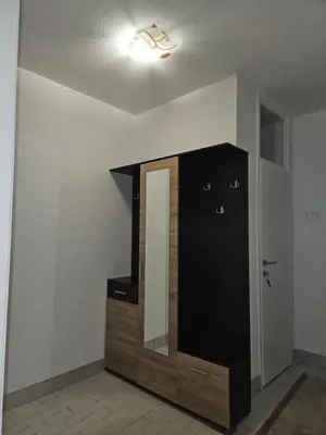 a black cabinet with a mirror in a room at Meri in Jajce