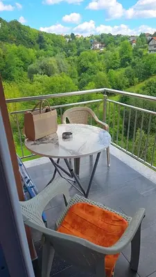 a purse sitting on a table on a balcony at Golden Sky in Cazin