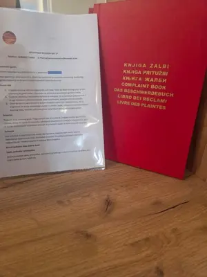 a book sitting on top of a wooden table at Golden Sky in Cazin