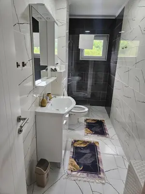 a white bathroom with a sink and a toilet at Golden Sky in Cazin