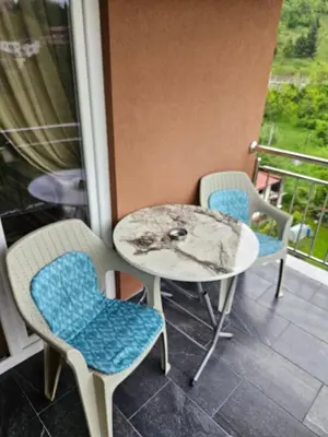 a table and chairs sitting on a balcony at Golden Sky in Cazin