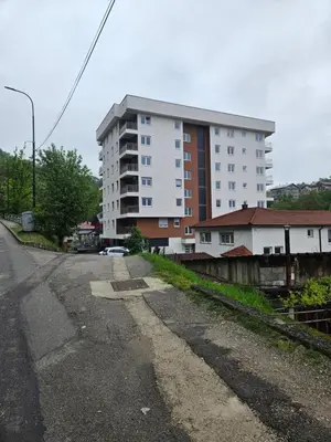 an empty street in front of a tall building at Golden Sky in Cazin
