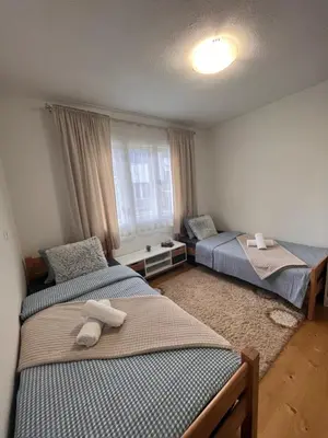 a bedroom with two beds and a window at Vito apartments in Jajce