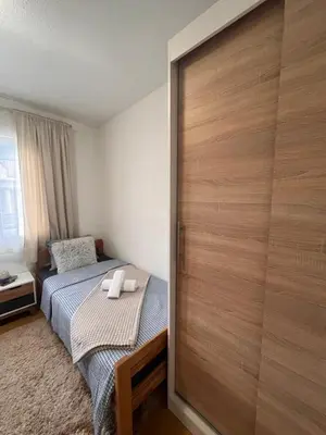 a bedroom with a bed and a sliding door at Vito apartments in Jajce