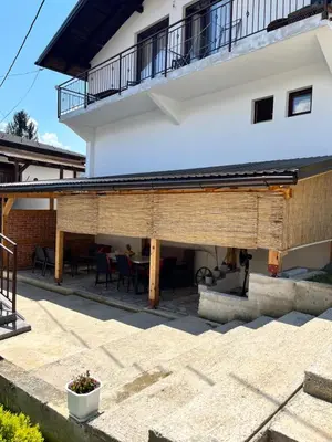 a patio with a building with a table and chairs at Vito apartments in Jajce