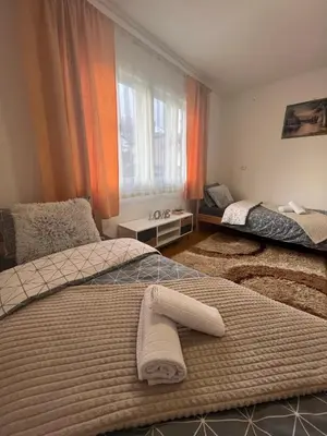 a bedroom with two beds and a window at Vito apartments in Jajce