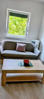 a living room with a couch and a table at Apartman Jakša in Prijedor