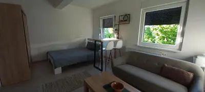 a living room with a couch and a window at Apartman Jakša in Prijedor