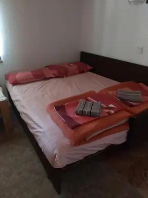 a bed with red towels on top of it at Vikendica odmor za dusu in Visoko