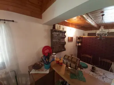 a kitchen with a wooden table and a dining room at Vikendica odmor za dusu in Visoko