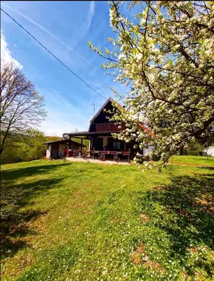 a large house with a grassy field in front of it at Vikendica odmor za dusu in Visoko