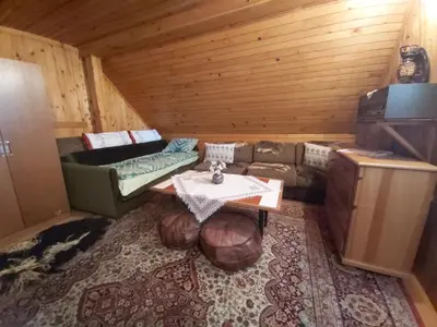 a room with a couch and a table in a cabin at Vikendica odmor za dusu in Visoko